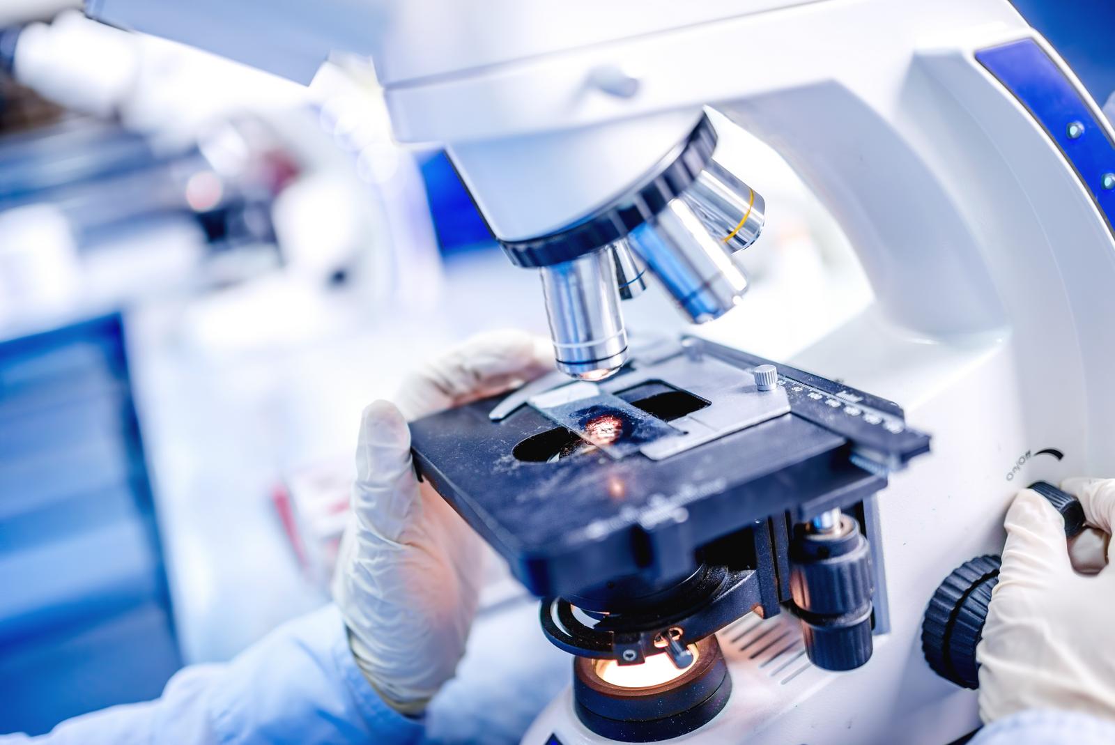 Details of medical laboratory, scientist hands using microscope for chemistry test samples